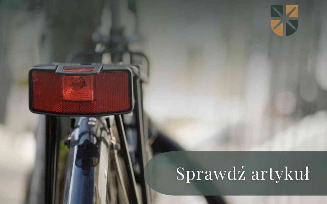 Tylne światło odblaskowe roweru na tle rozmytego otoczenia.